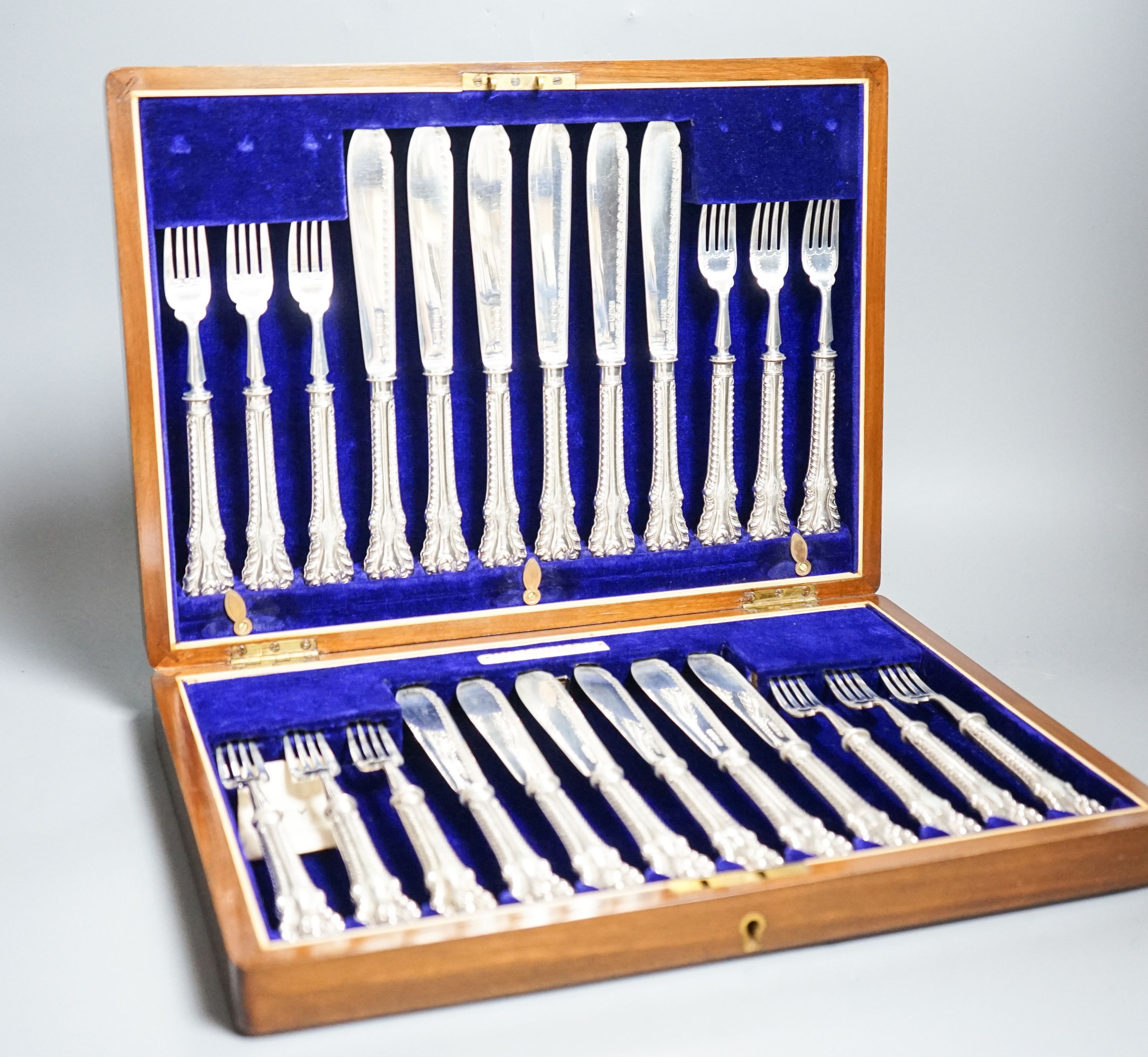 A cased set of twelve pairs of Edwardian silver fish eaters, Allen & Darwin, Sheffield, 1909 (loaded handles)